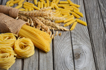 Raw pasta on rustic background