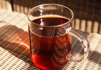 Glass cup with black tea