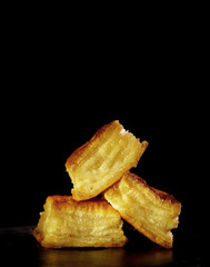 Delicious honey pastries on black background