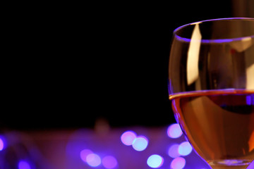 Wine glass with bokeh on dark background