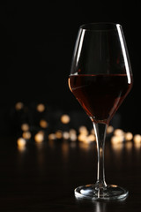 Wine glass with bokeh on dark background