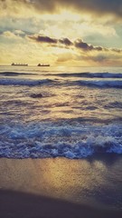 Sunrise ans splashing waves on the beach