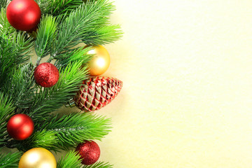 Christmas fir tree branches with toys on paper background