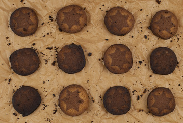 Burnt cookies with crumbs on backing crumpled paper.