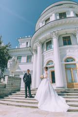 Groom and bride near Wedding palace