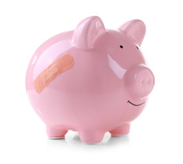 Piggy Bank with adhesive bandage, isolated on white