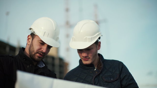 Engineer and client looking on project on the construction site