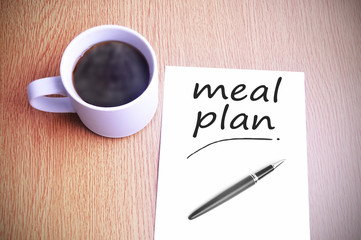 Coffee on the table with note writing writing meal plan