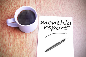Coffee on the table with note writing writing monthly report - 97753309
