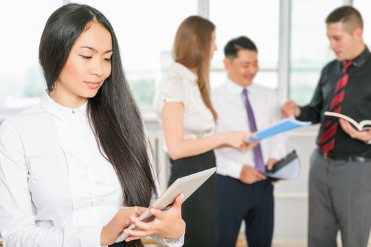 Successful asian business woman holding tablet PC