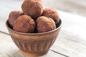 Bowl of meatballs on the wooden background