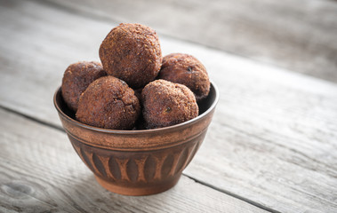 Bowl of meatballs on the wooden background