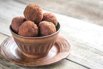 Bowl of meatballs on the wooden background
