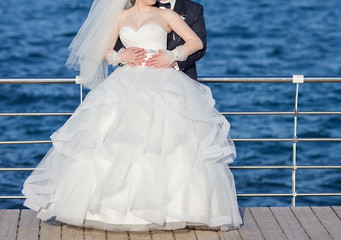 Plakat bride and groom posing together outdoors on a wedding day