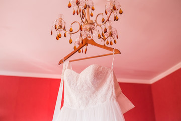 Wedding dress hanging on a shoulders