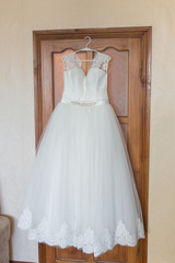 Fototapeta na wymiar Wedding dress hanging on a shoulders