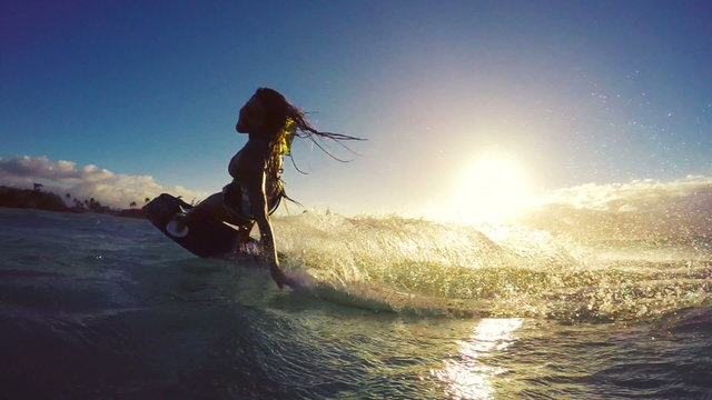 Extreme Kitesurfing at Sunset. Summer Ocean Sport in Slow Motion. Girl Kite Surfing in Bikini 