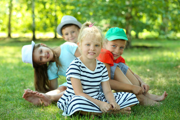 Naklejka na ściany i meble Happy active children on green grass in park