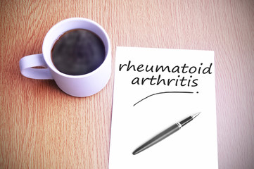 Obraz na płótnie Canvas Coffee on the table with note writing rheumatoid arthritis