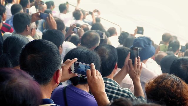 Crowd Of People Filming Event With Smartphones