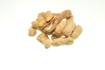 salted peanuts on white background
