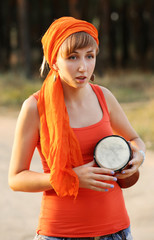 Bright smiling girl with jembe in the forest outdoors
