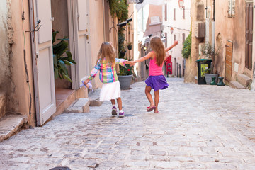 Obraz na płótnie Canvas Adorable fashion little girls outdoors in European city