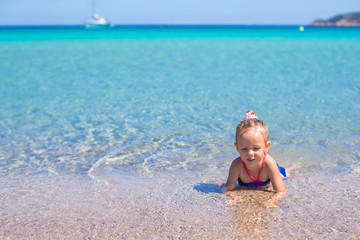 Adorable little girl at beach during summer vacation