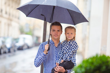 Father and his little daughter outdoors in European city