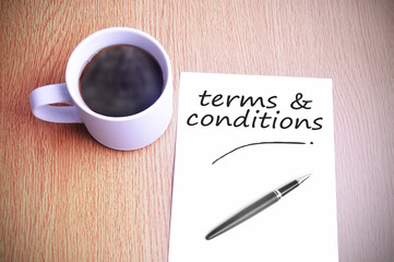 Coffee on the table with note writing writing terms & conditions
