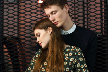 a young couple in love standing with eyes closed