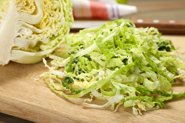 Cut savoy cabbage on wooden cutting board