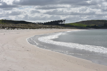 A long white sand beach north of Auckland.
