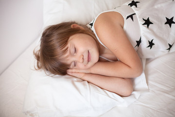 Obraz na płótnie Canvas girl in a bright dress sleeping on the bed