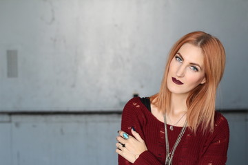 Fototapeta premium Androgyny ginger female model in Heroin chic style with copy space on the left side.