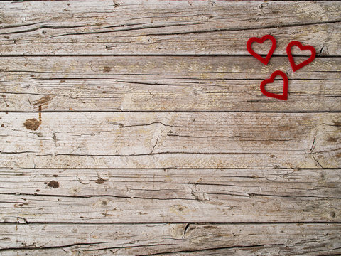 Red heart shape on wooden background