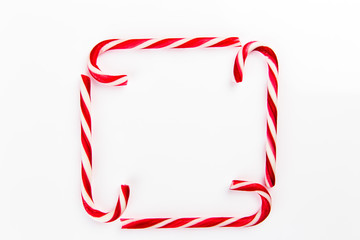 Candy canes on white isolated composition background sweets