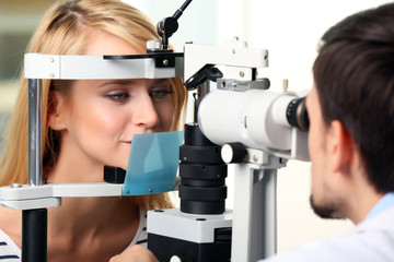 Fototapeta premium Adult male doctor examing adult female patient