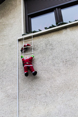 Santa climbing up the ladder