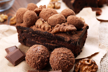 A piece of chocolate cake with walnut on the table, close-up