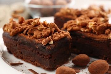 Fototapeta na wymiar Pieces of chocolate cake with walnut on the table, close-up