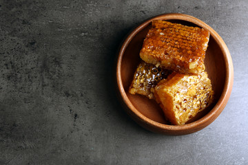 Honeycombs on plate on gray background