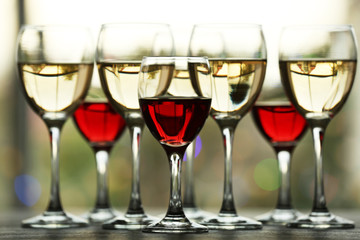 Wine glasses with wine on a table outside