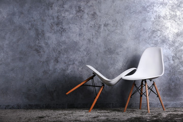 Stylish conception with two white chairs on grey background