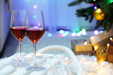 Two glasses of wine on christmas decor background