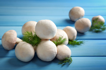 Mushrooms on color wooden surface