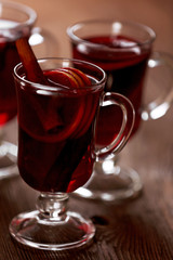 Mulled wine on wooden table, close-up