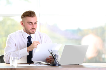 Businessman working with laptop in office