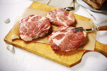 Marbled beef steak and spices on wooden background