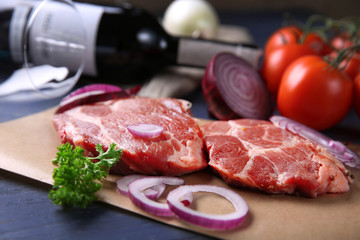 Marbled beef steak with bottle of wine and spices on wooden background
